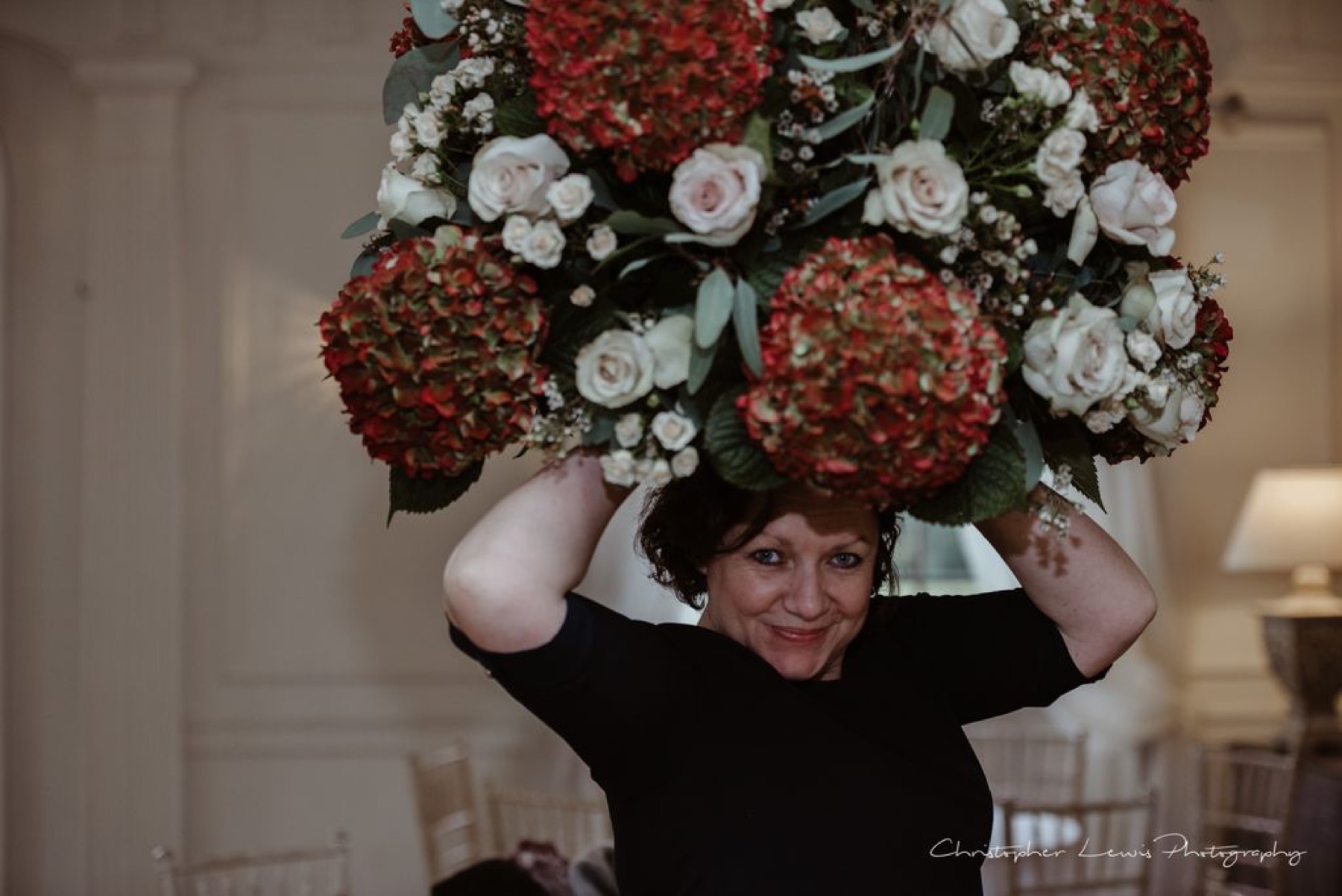 Sarah carrying an abundant floral arrangement